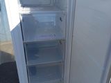 a white refrigerator with its door open on a pallet