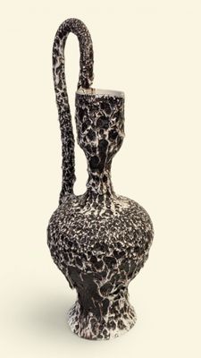 a black and white vase with a handle on a white background