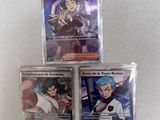 three pokemon cards are sitting on top of each other on a table