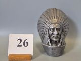 a silver statue of a native american man next to a table number