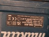 a close up of a blue machine with a black label on it
