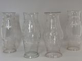 four glass vases sitting next to each other on a table