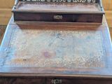 a small wooden desk with a mirror on top of it