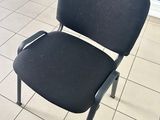 a black chair that is sitting in the corner of a room