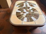 a table with a mosaic design on it in a room