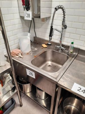 a kitchen with a stainless steel sink and a stainless steel counter