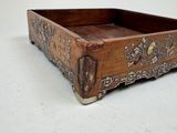 a small wooden box with a decorative design on it