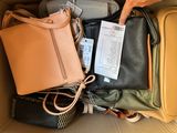 a box full of purses and a handbag with a price tag on it