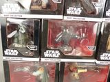 many star wars action figures on display in a store