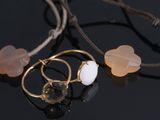 three pieces of jewelry sitting on top of a table next to each other