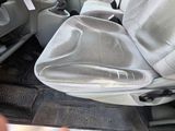 a seat in the back of a car that is covered with a cloth