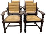 two wooden chairs with wicker seats and a cane back