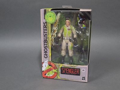 figurine Ghostbusters dans sa boîte, posée sur une surface grise
