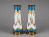 pair of blue and white vases with gold decoration on them