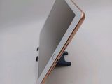 a tablet computer sitting on a stand on a table
