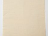 an old piece of paper on a white surface with a piece of paper in the middle of it