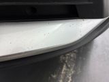 a close up of the front bumper of a car with dirt all over it
