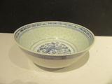 a blue and white bowl sitting on a white table