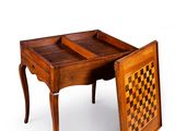 a wooden table with a chess board on top of it