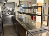 a kitchen with stainless steel counter tops and stainless steel appliances