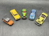 several toy cars are lined up in a row on a table