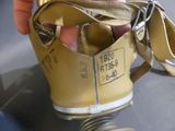 a hand holding a gas mask with a gas can attached to it