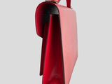 a close up of a pink and black purse on a white background