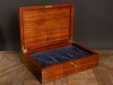 an old wooden box with velvet linings on a wooden floor
