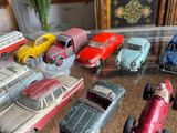 a lot of toy cars that are on a table