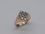 a close up of a gold ring with diamonds on a white background