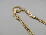 a close up of a gold chain with a clasp on it