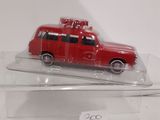 a red toy car on display in a clear box