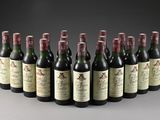 six bottles of wine lined up in a row on a gray surface