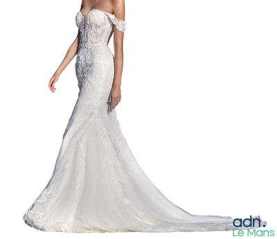 a woman in a wedding dress posing for a picture