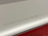 a close up of a laptop on a red table