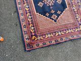a rug on the ground next to a pair of orange cones