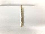 a gold bracelet with a diamond bar in the middle of it