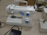a white sewing machine sitting on the floor next to other sewing machines