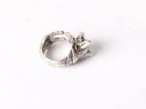 silver ring with a flower on the middle of it on a white surface