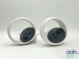 pair of white and black round earrings with buttons on them