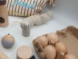 a table with eggs, eggshells, a bag of eggs, and other items on it