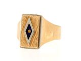 an image of a gold ring with a blue stone in the center