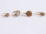 a group of five gold rings with diamonds on them