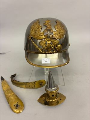 a silver helmet with a gold eagle on it next to a pair of scissors