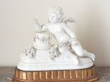 a figurine of a cupid on a marble table