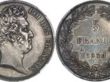 a close up of a silver coin with a crown on it
