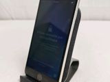 a cell phone that is sitting on top of a stand