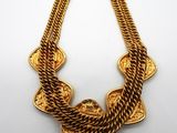 a gold necklace on a white background