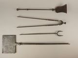 several old tools are arranged on a white surface with a white background