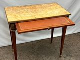 a small wooden table with a marble top and two drawers